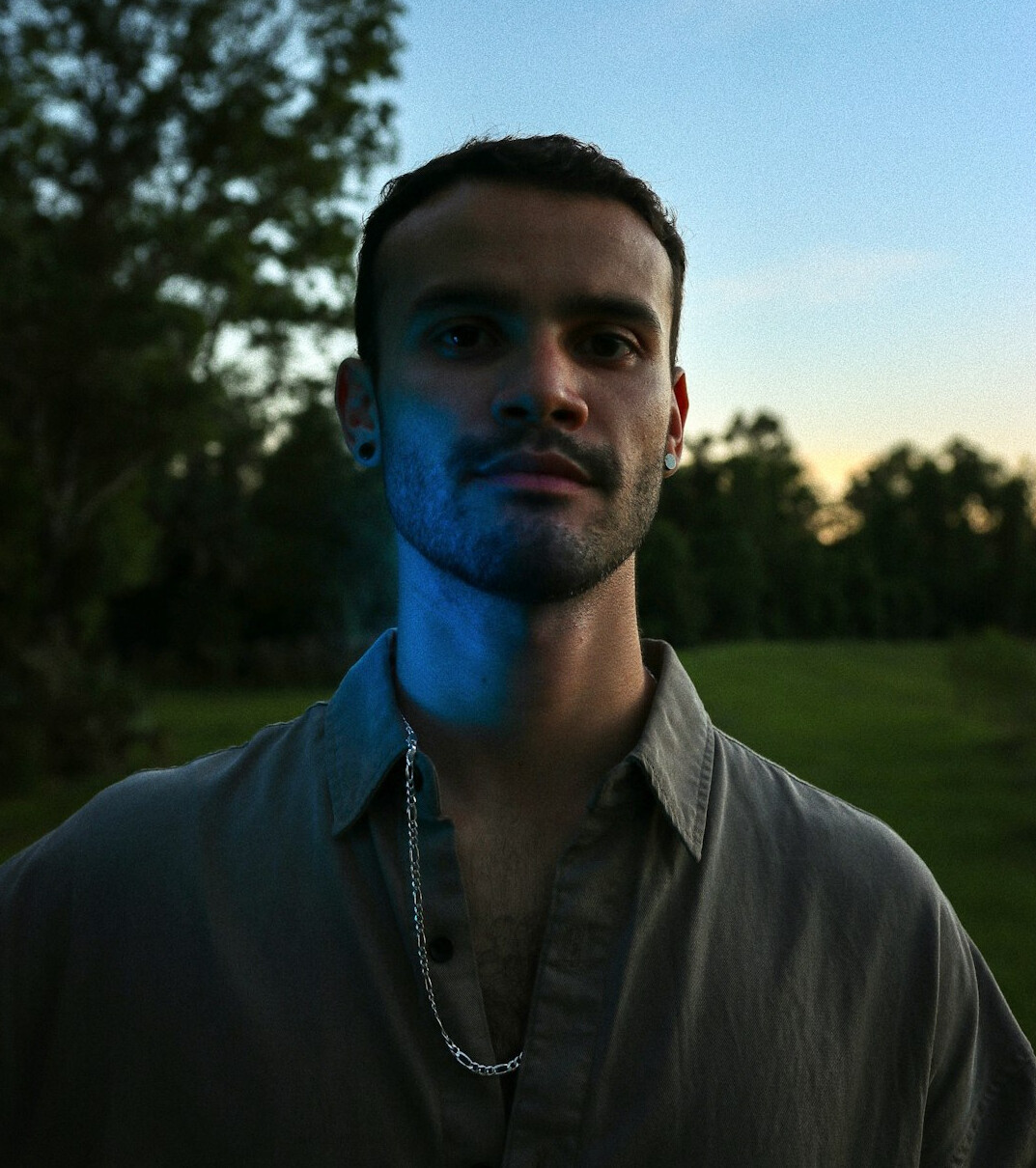 Portrait of a man with short dark hair and a light beard